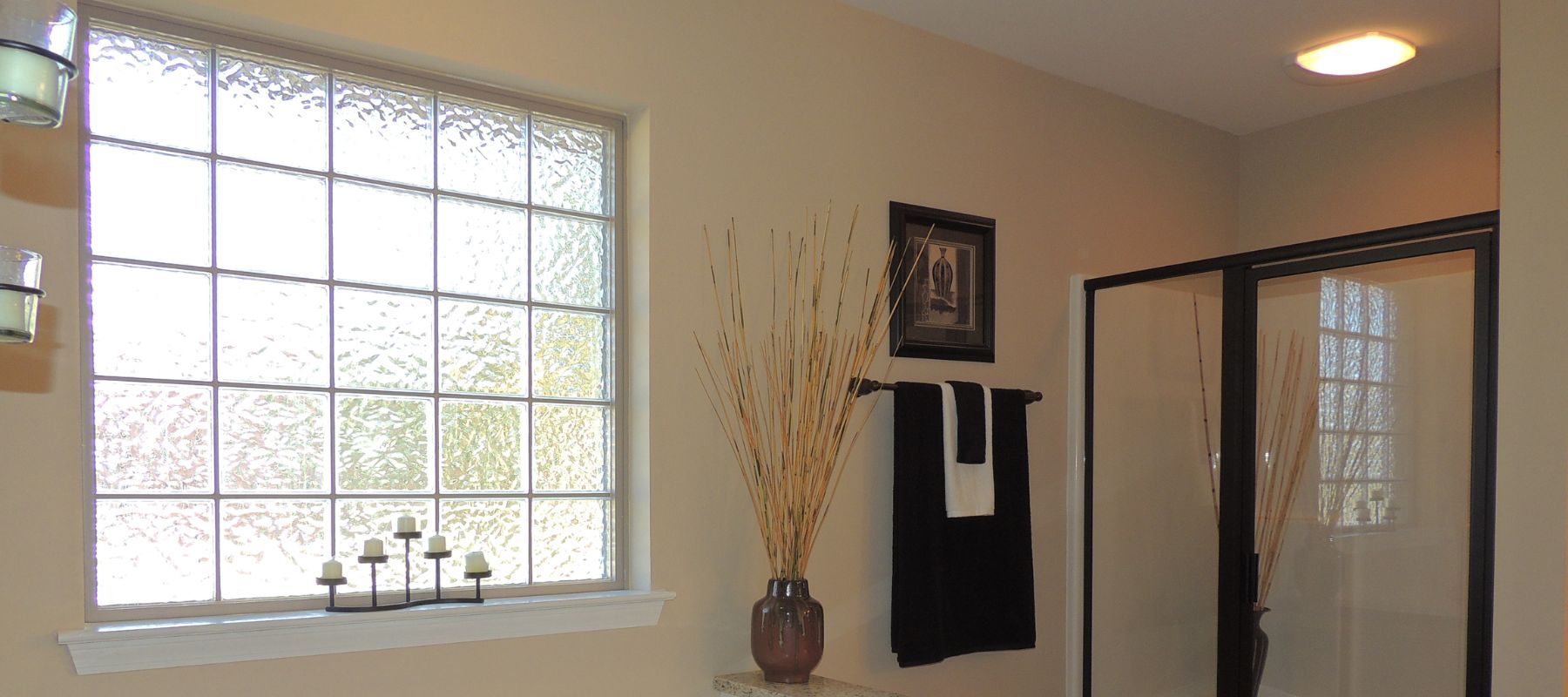 Frosted glass block window in a beige bathroom allowing privacy and natural light